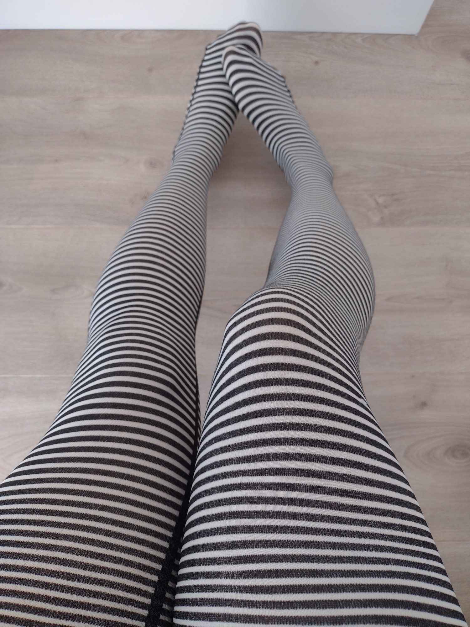 Black and cream fine horizontal stripe tights, worn on legs