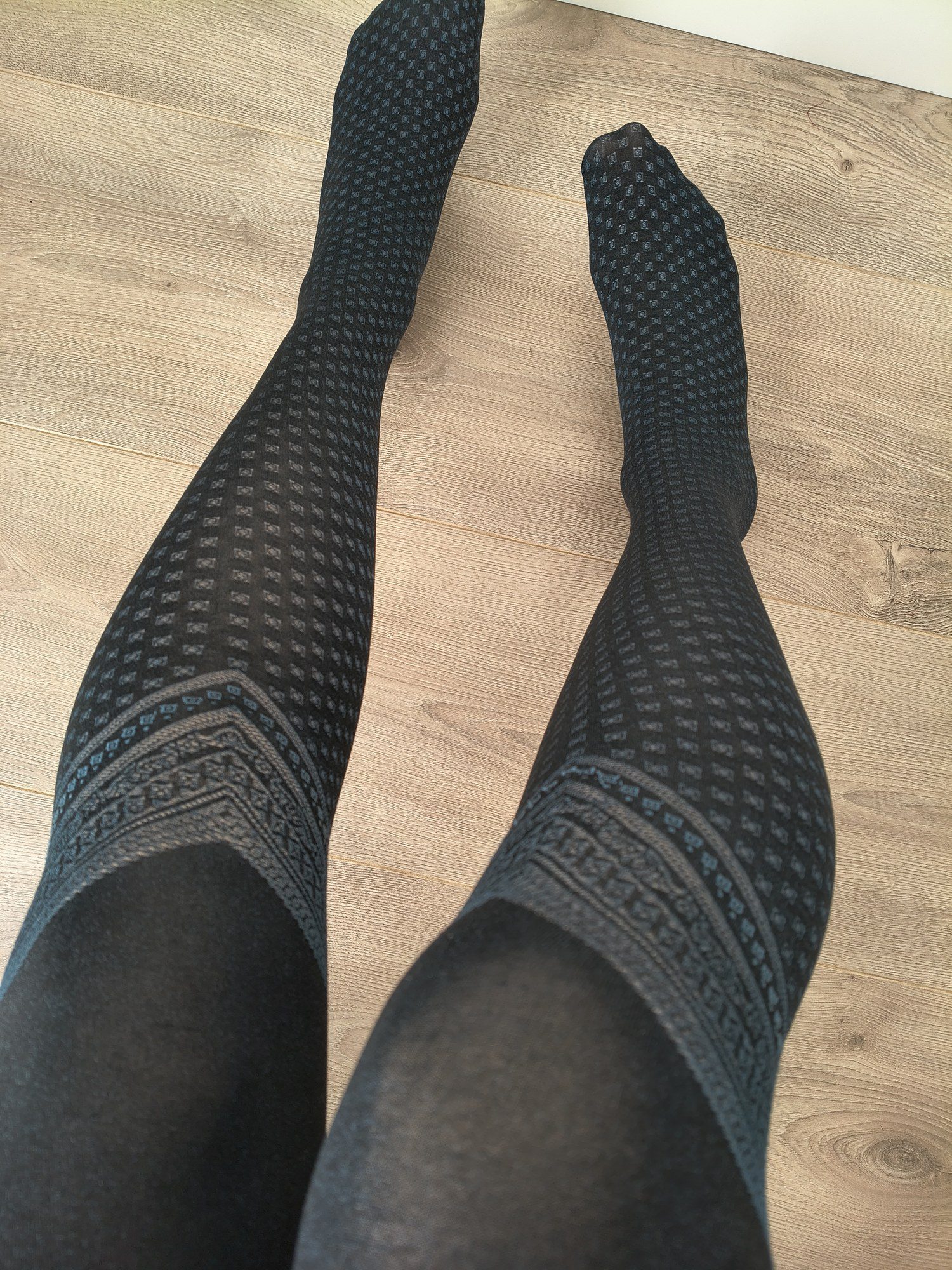 Black micro-diamond print tights with an embroidered fair isle border at the thigh, worn