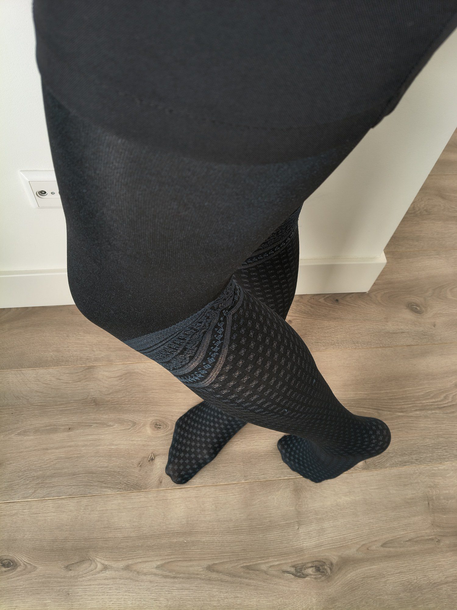 Close-up of the fair isle border detail on black micro-diamond faux thigh-high tights