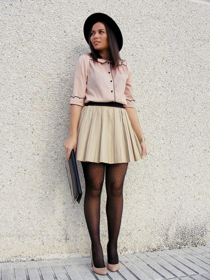 Salmon blouse with pleated tan skirt and black polka dot tights