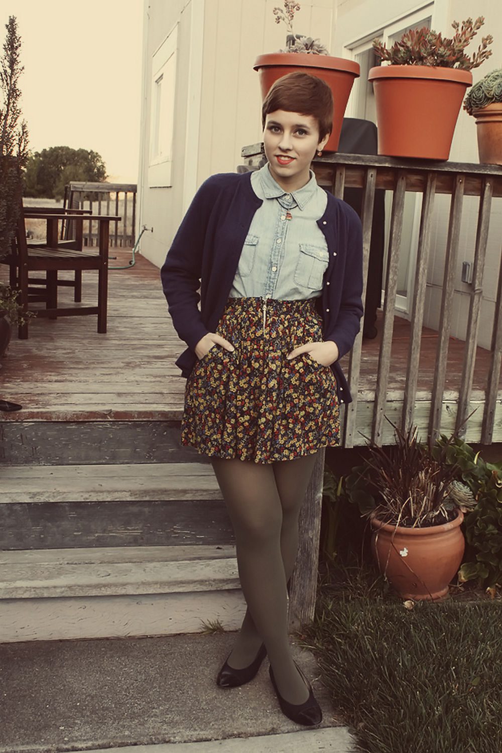 Grey tights with floral print skirt, denim shirt and purple coat