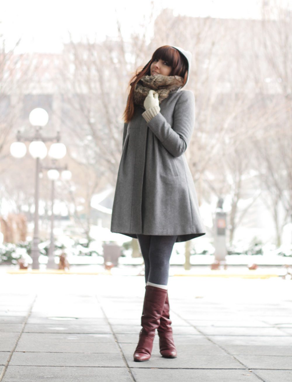 Grey tights with socks layered over boots and long grey coat