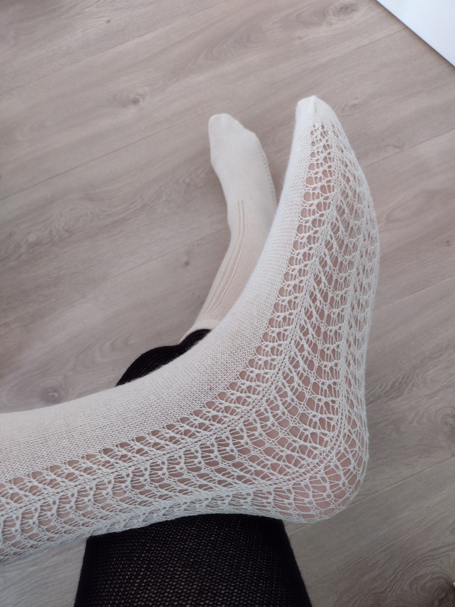 Close-up detail of the ivory ribbed knit texture on the two-tone faux thigh-high tights