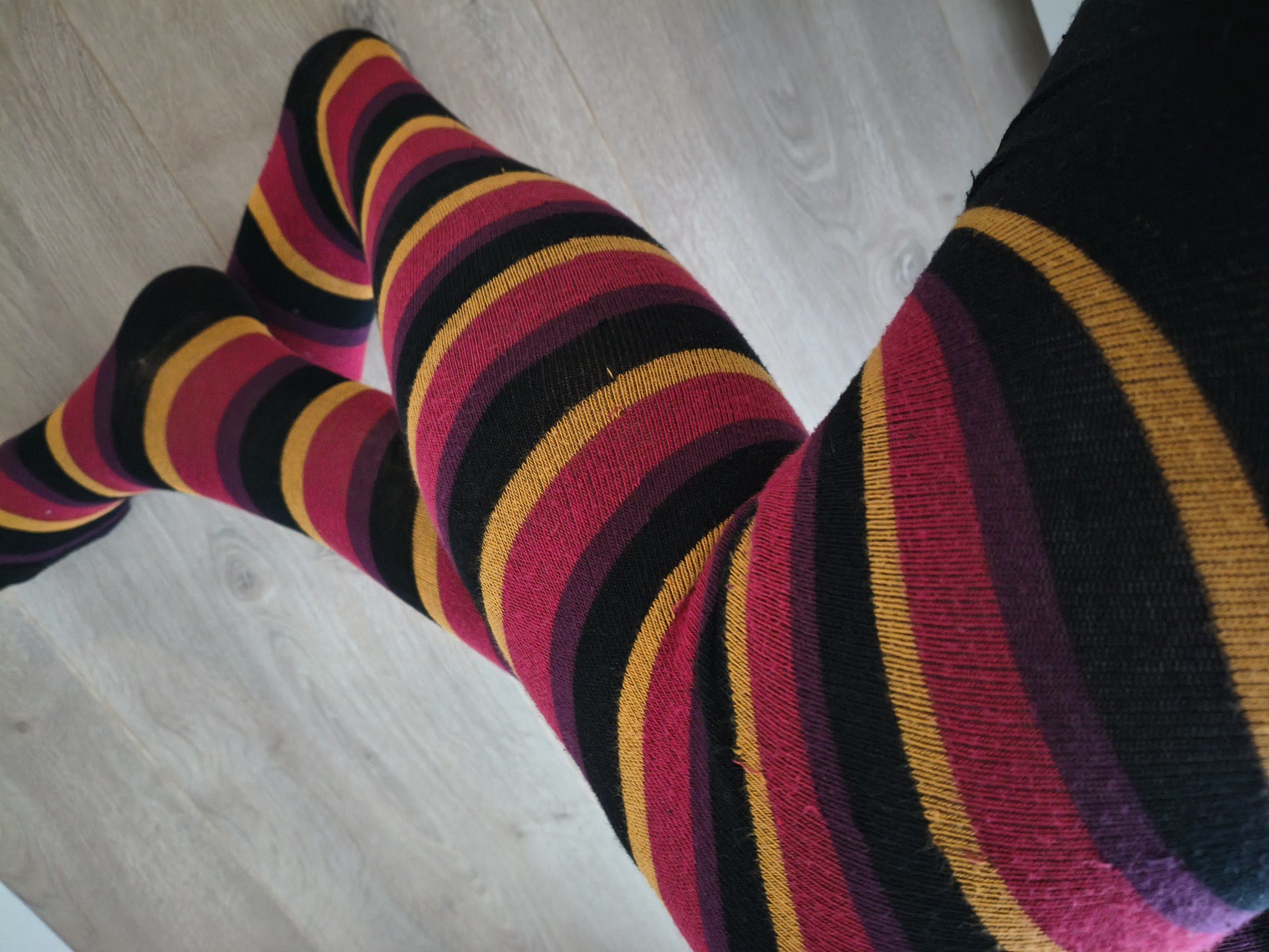 Close-up of multicolor horizontal stripe tights worn on legs