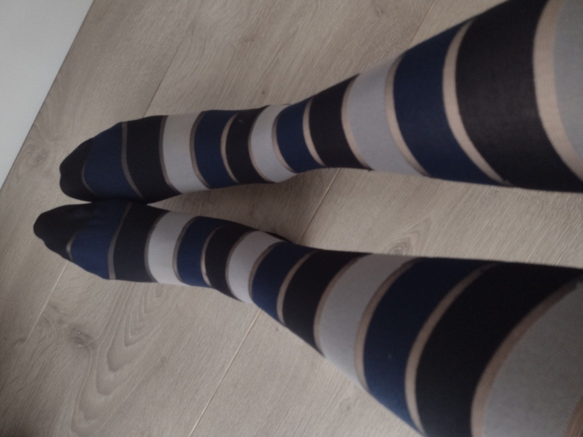 Full leg view of navy blue horizontal stripe tights
