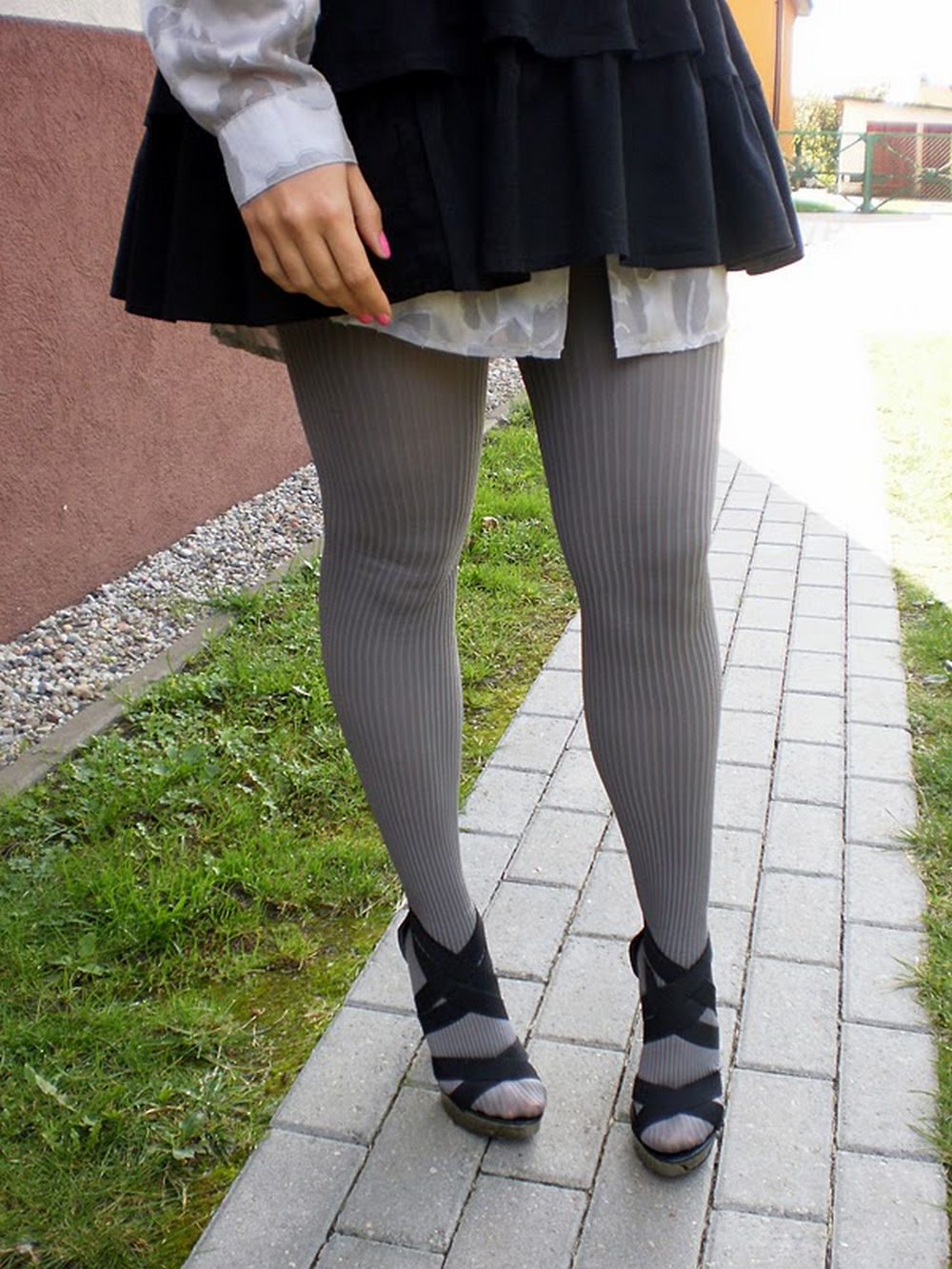 Ribbed grey tights close up with strappy heels