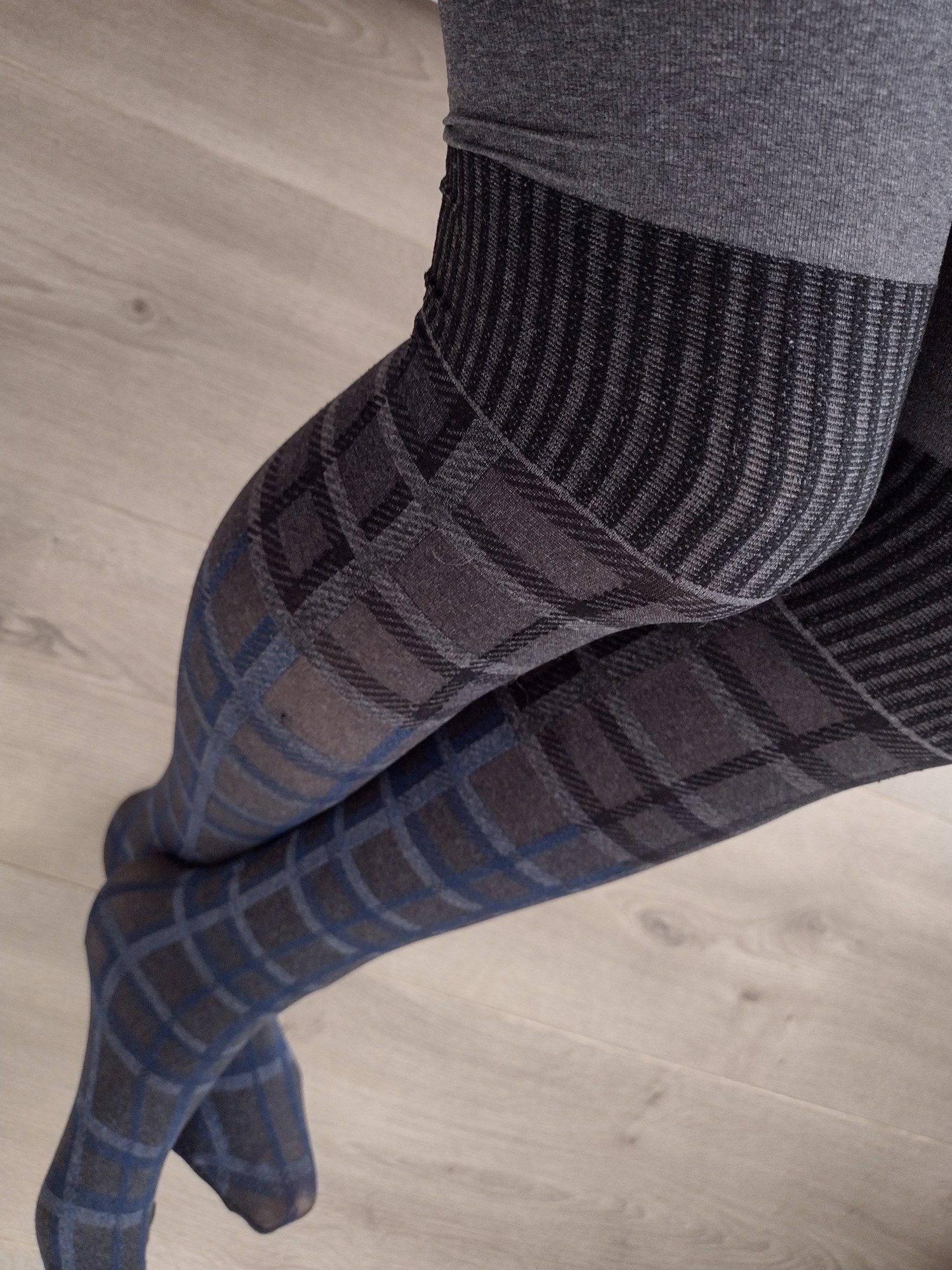 Grey-blue windowpane check tights with a contrast faux-stocking top, worn on legs