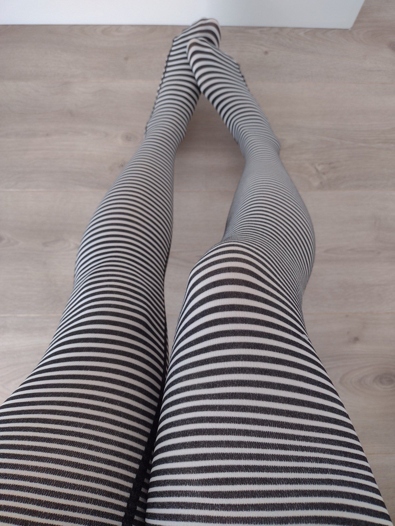 Black and cream fine horizontal stripe tights, worn on legs