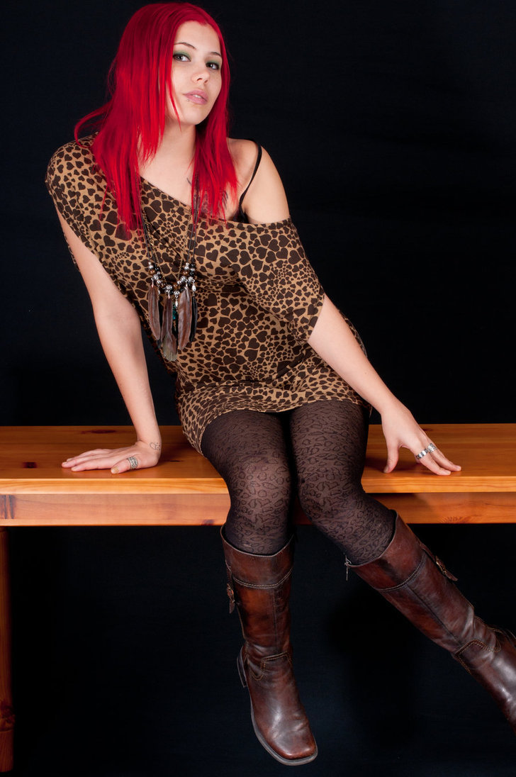 Patterned black tights with tall dark brown leather boots and a leopard print dress