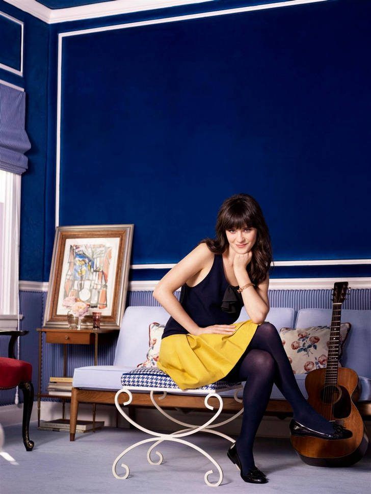 Zooey Deschanel in dark blue tights and top with yellow skirt and black flat shoes