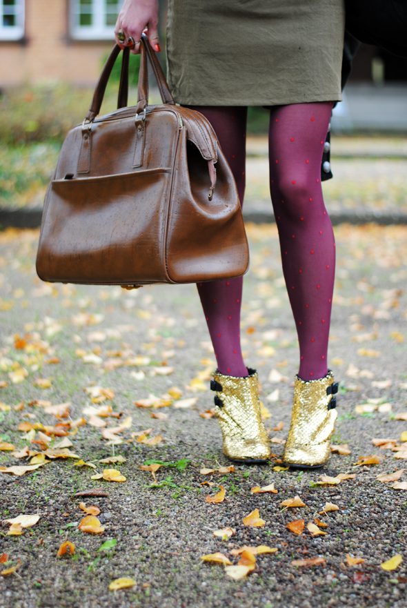 Detail of burgundy tights with red polka dots, golden boots and dark green skirt worn by Monika Krawczyk