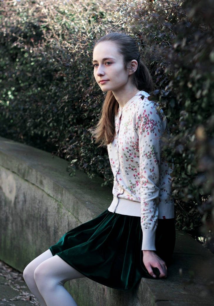 White opaque pantyhose with green velvet skirt and floral print cardigan worn by Wioletta