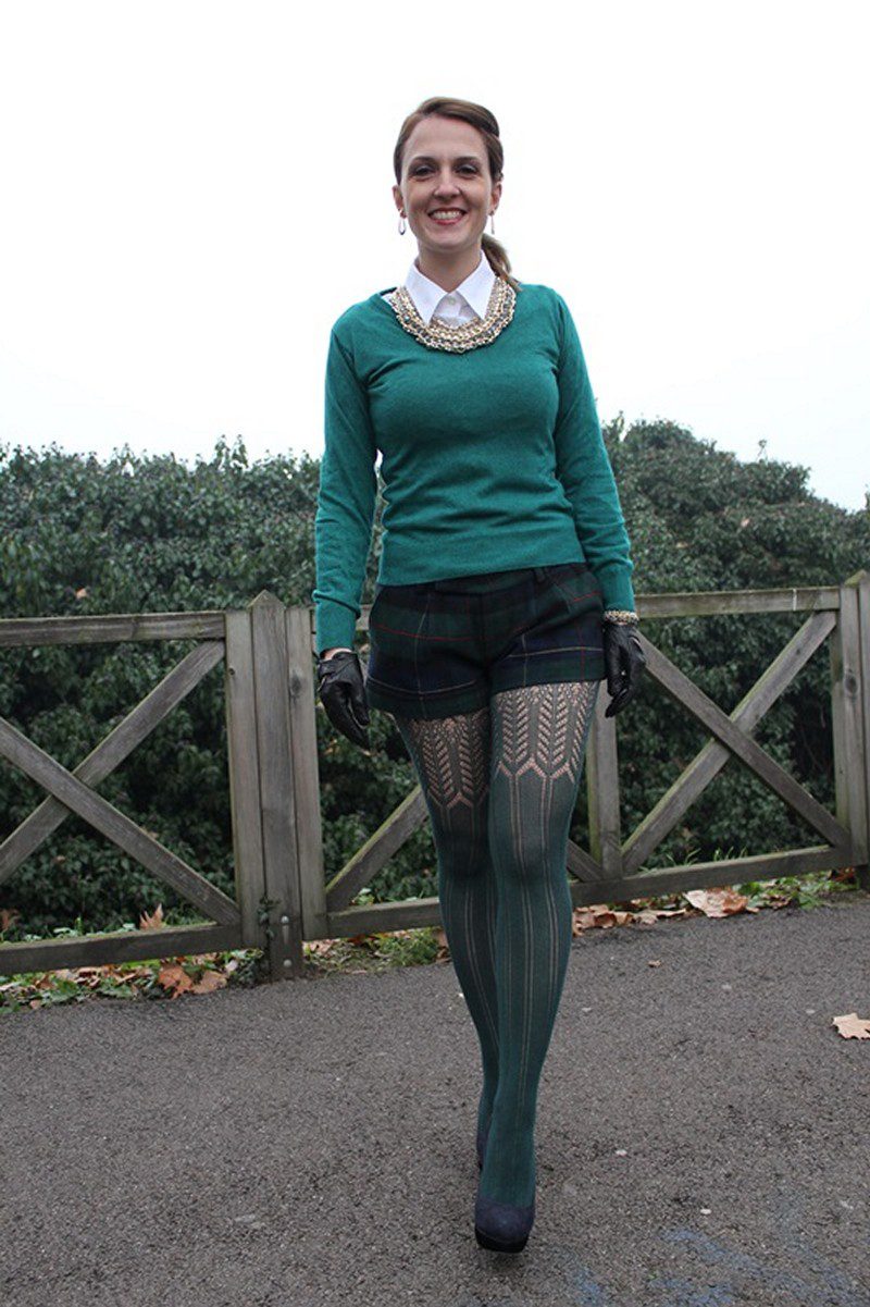 Green peacock patterned tights, shorts and green cardigan over white blouse worn by Margaret