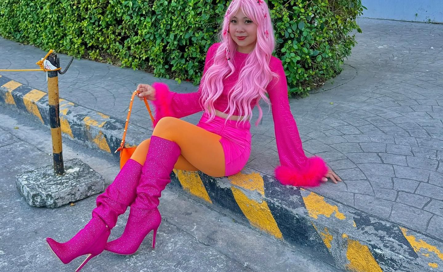 Orange pantyhose with pink heel boots by Janine Manzano