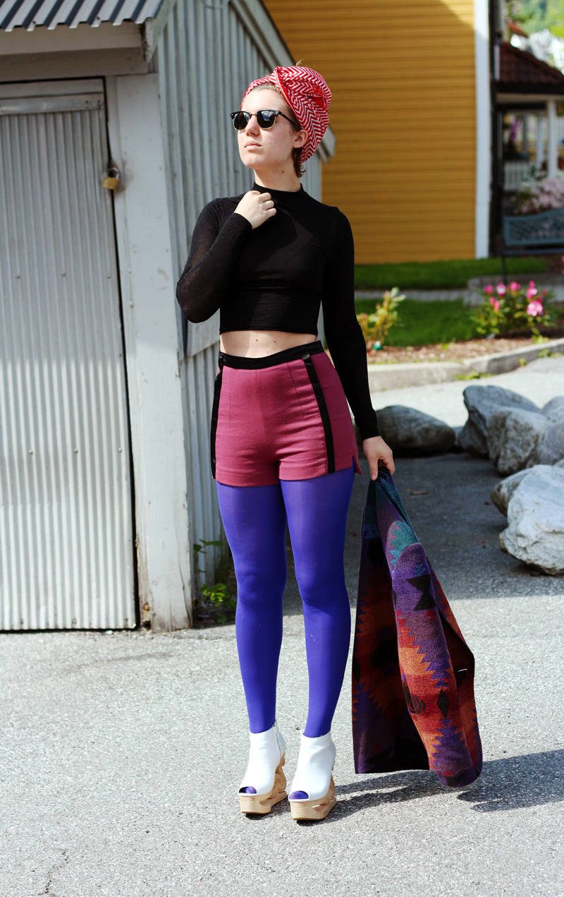 Shiny opaque tights, burgundy shorts, sheer black top and white shoes with carved wooden heels worn by Iben Bergstrøm
