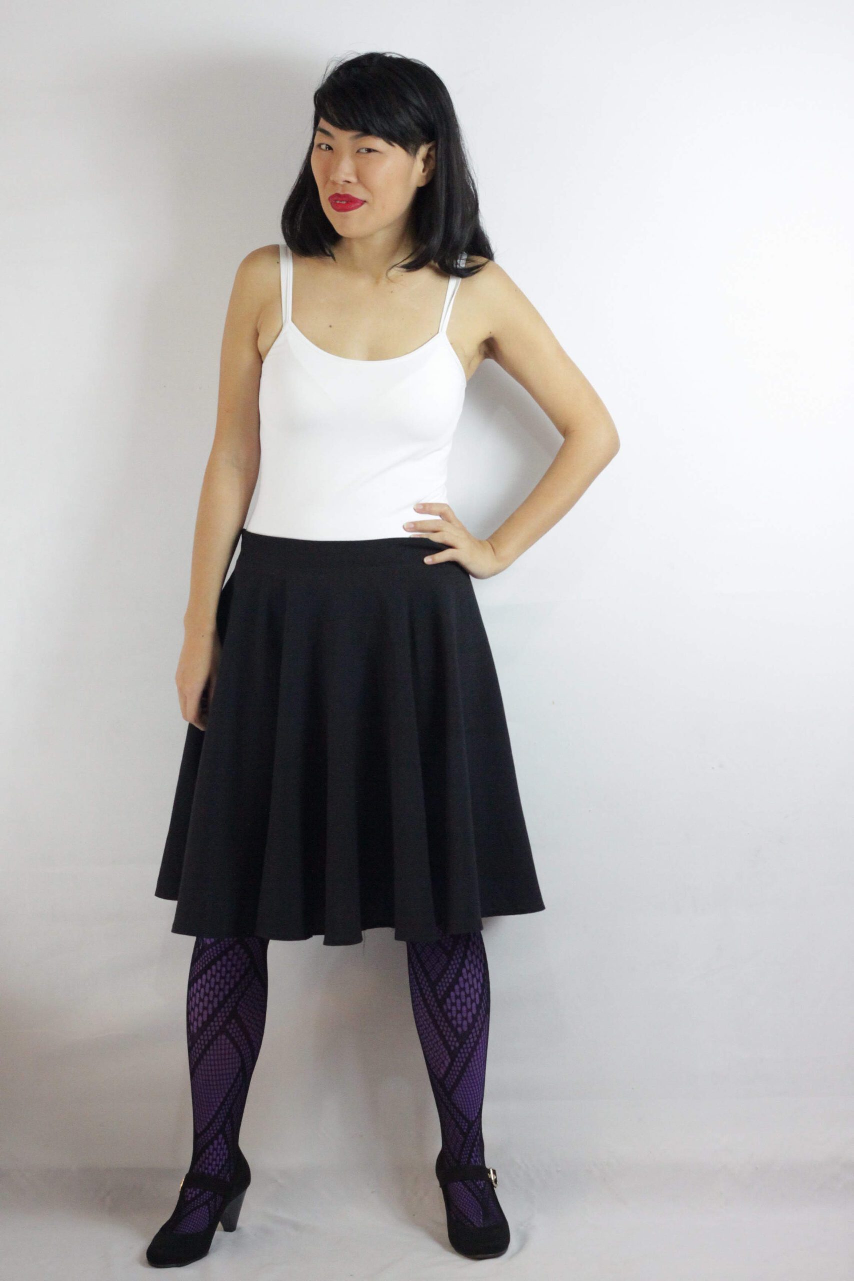 Purple lace pantyhose and simple black skirt worn by Isis Tomie