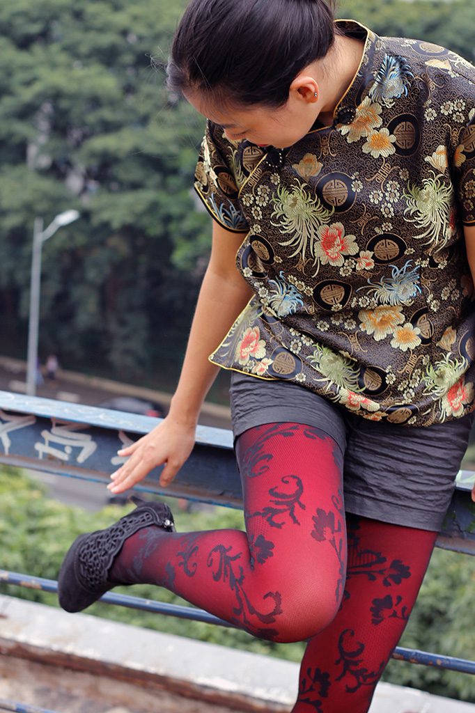 Red and black lace pantyhose and Chinese dress being worn by Isis Tomie