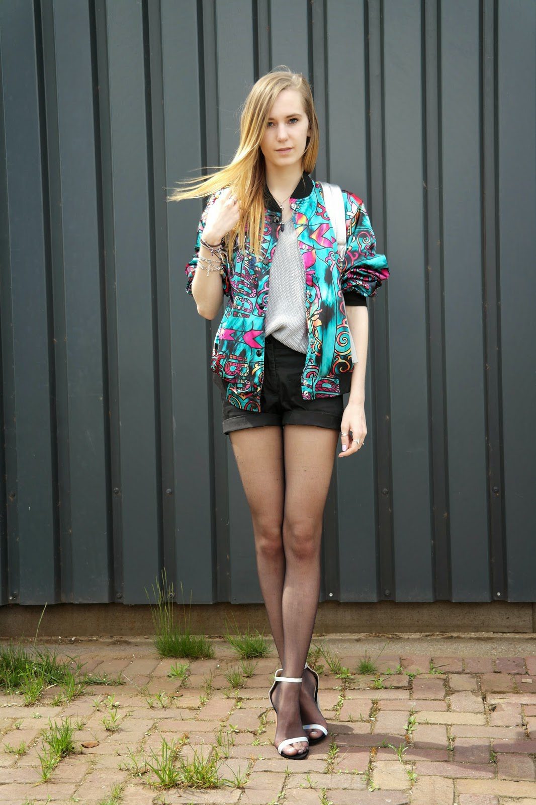 Sheer black pantyhose and multicolored jacket worn by Saskia van Rij
