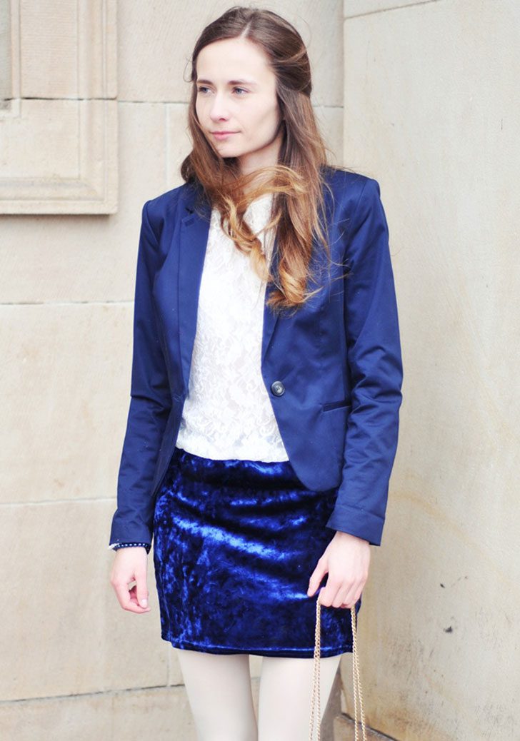White opaque tights and lace shirt with blue blazer, skirt and clutch worn by Wioletta
