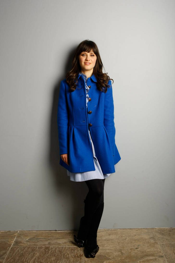 Zooey Deschanel in black opaque tights, white dress and long electric blue coat on top