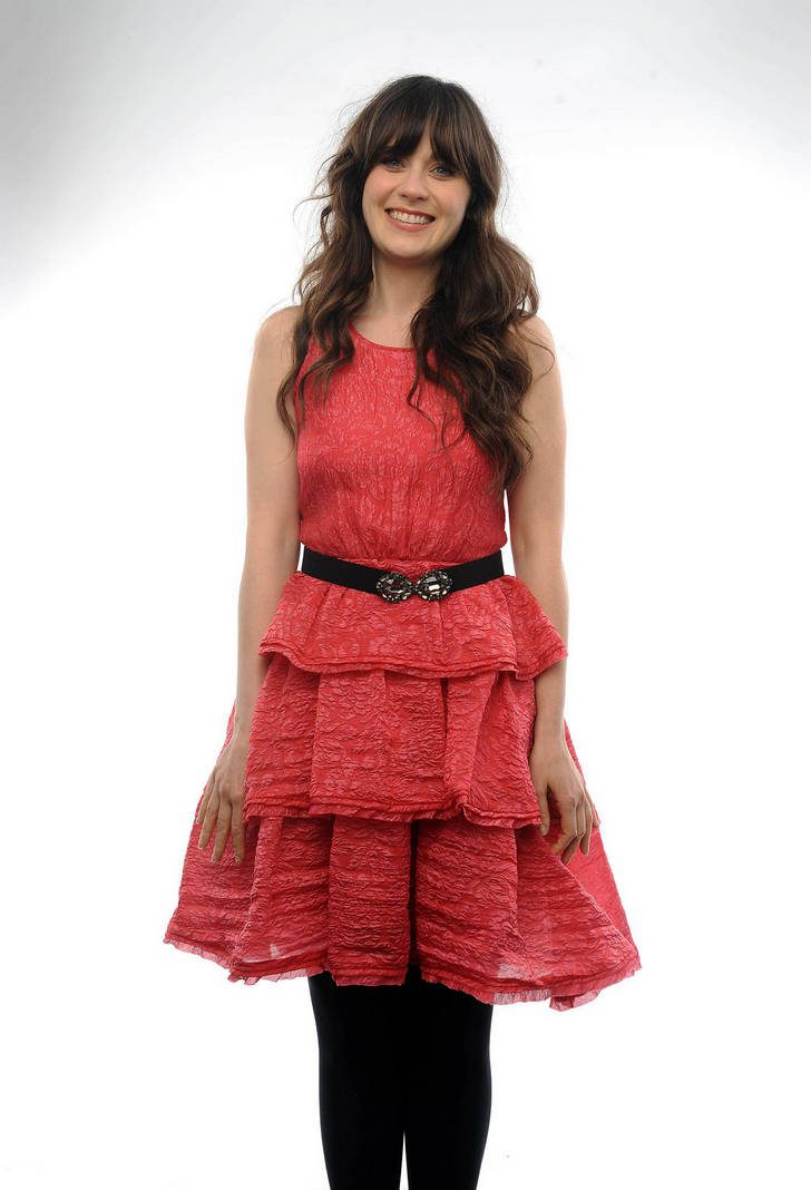 Zooey Deschanel in black opaque tights and pink pleated chiffon dress