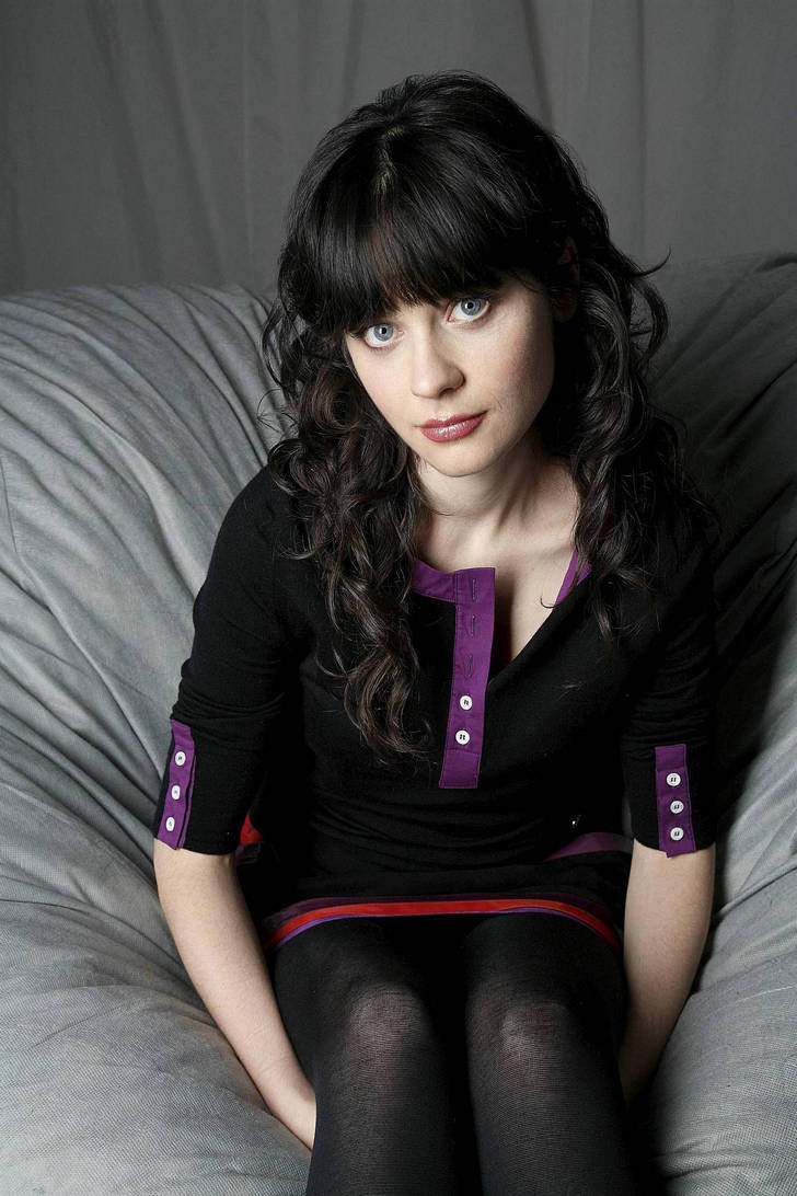 Zooey Deschanel in black opaque pantyhose and dress with purple and dark red details